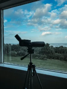 Telescope by a window